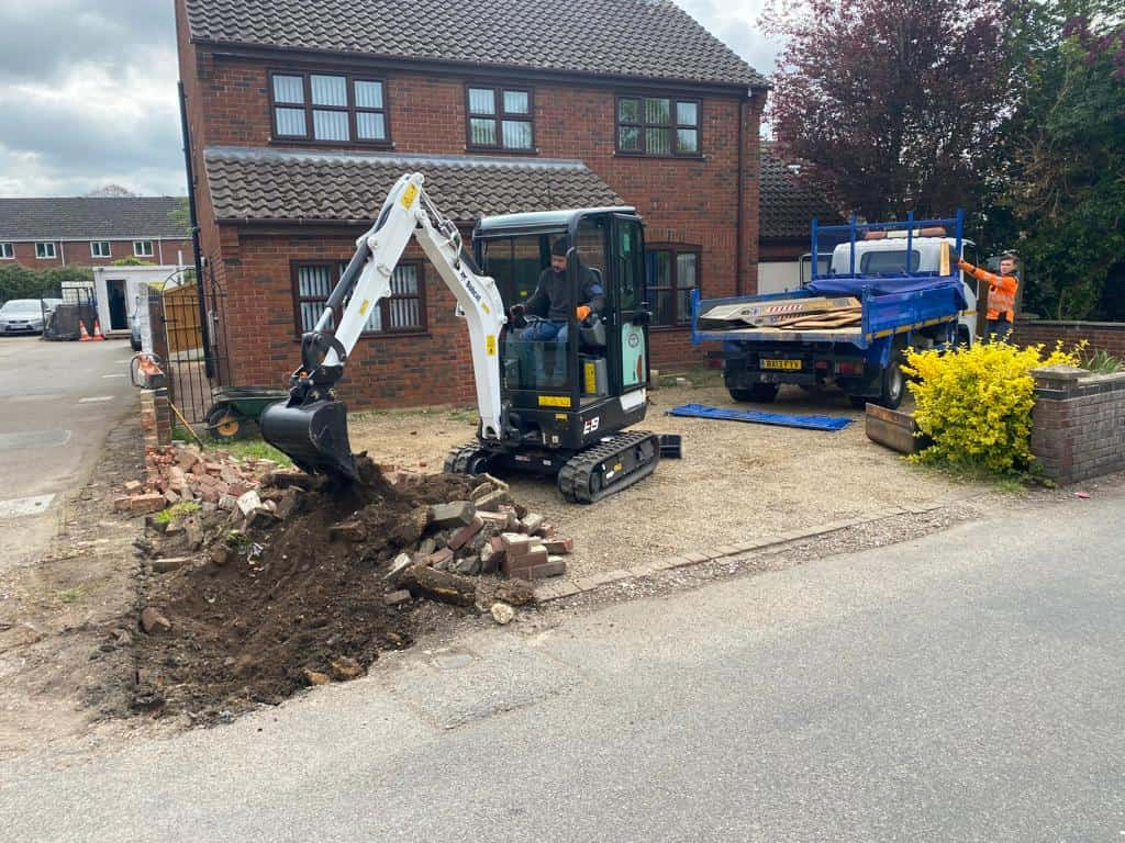 This is a photo of an operative of St Neots Driveways Digging out for a new tarmac driveway